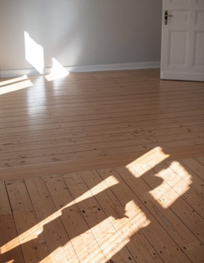 a wood floor with a white door